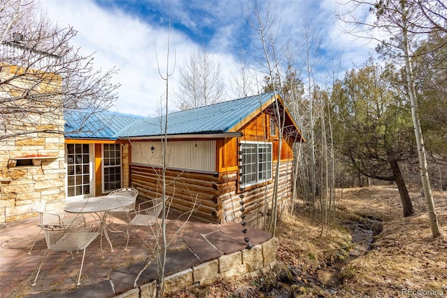 9185 US Highway 285, Salida, CO 81201 - view of home's exterior featuring a patio area and a metal roof