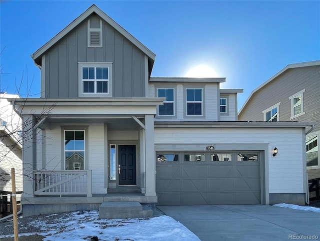 traditional-style house featuring covered porch, concrete driveway, board and batten siding, and a garage