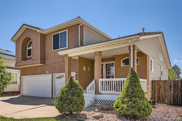 20336 E 48th Dr, Denver, CO 80249 - view of front facade with a porch, an attached garage, stucco siding, concrete driveway, and fence