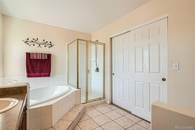 20336 E 48th Dr, Denver, CO 80249 - full bathroom with a garden tub, a stall shower, tile patterned flooring, and vanity
