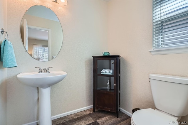 20336 E 48th Dr, Denver, CO 80249 - bathroom featuring wood finished floors, toilet, and baseboards