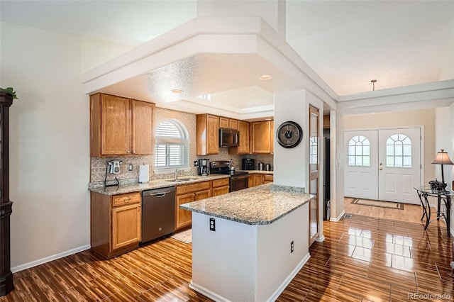 20336 E 48th Dr, Denver, CO 80249 - kitchen featuring stainless steel appliances, brown cabinets, backsplash, and light wood-style floors