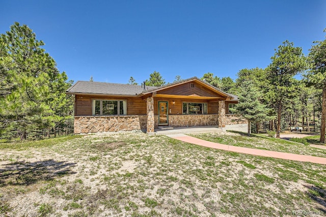 18150 Martingale Rd, Monument, CO 80132 - view of front of house featuring stone siding and a porch