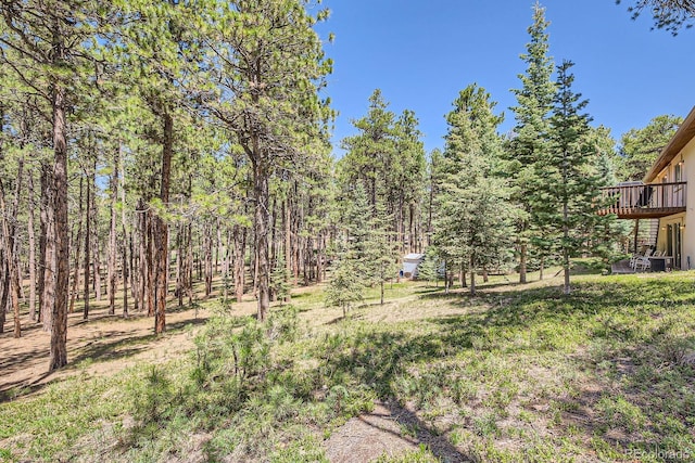18150 Martingale Rd, Monument, CO 80132 - view of yard with a wooden deck and a wooded view