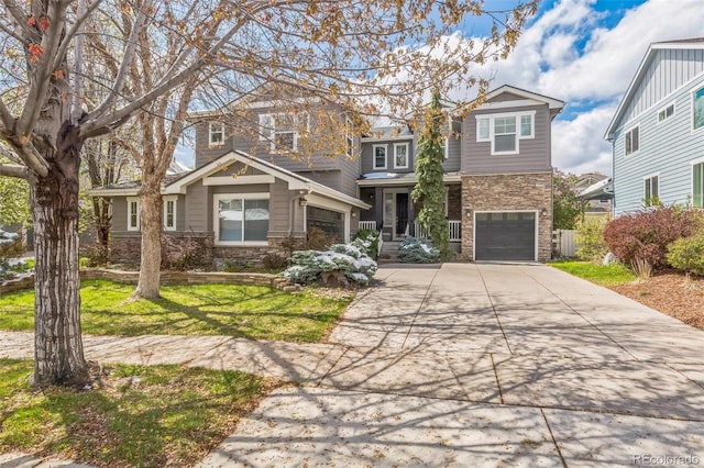 craftsman house featuring concrete driveway, stone siding, a front lawn, and an attached garage