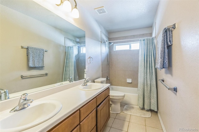 bathroom with tile patterned floors, toilet, visible vents, and a sink