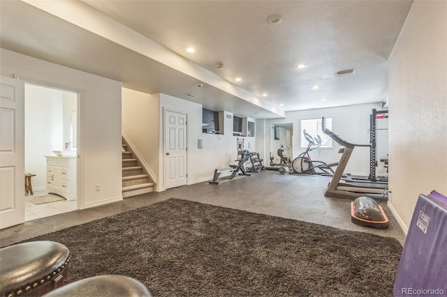 workout area featuring baseboards and recessed lighting