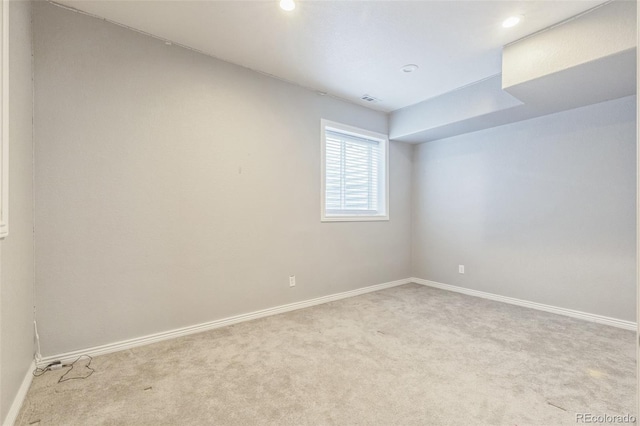 carpeted empty room with baseboards and recessed lighting