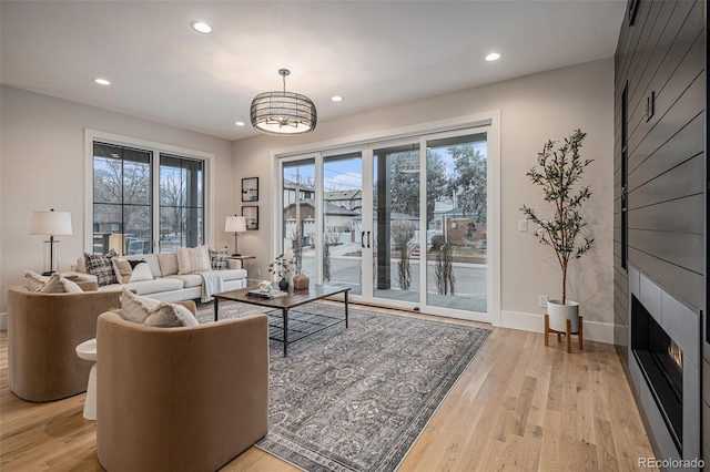 living room with a fireplace and light hardwood / wood-style floors