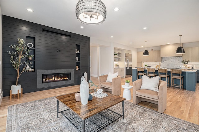 living room with a fireplace and light hardwood / wood-style flooring