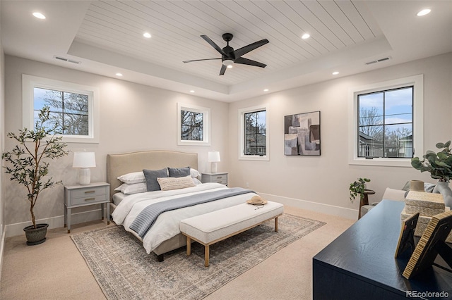 bedroom with ceiling fan, wooden ceiling, and a tray ceiling