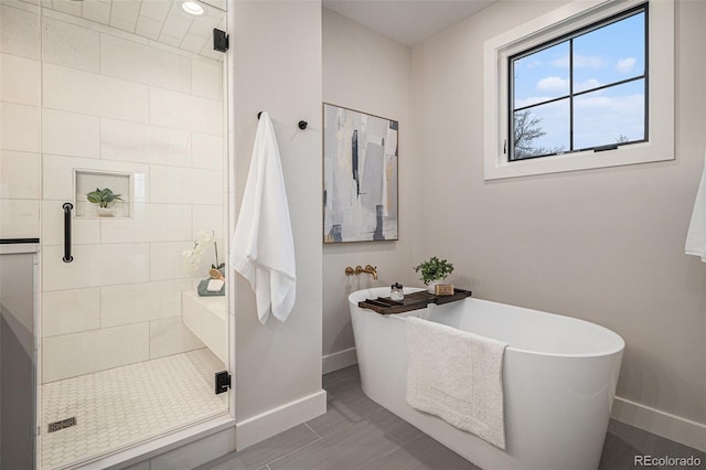 bathroom featuring shower with separate bathtub