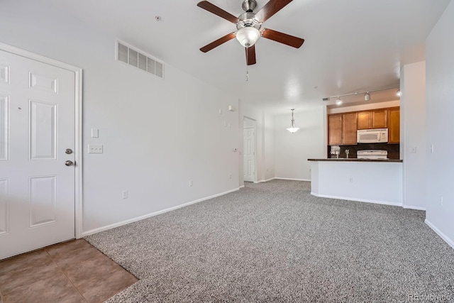 2705 S Danube Way Unit 110, Aurora, CO 80013 - unfurnished living room with a ceiling fan, rail lighting, carpet, and baseboards