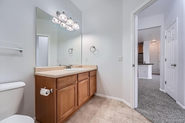 2705 S Danube Way Unit 110, Aurora, CO 80013 - bathroom featuring vanity, toilet, baseboards, and tile patterned floors