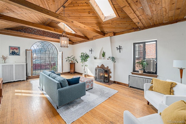 living room with a fireplace with flush hearth, radiator heating unit, wood ceiling, and wood-type flooring