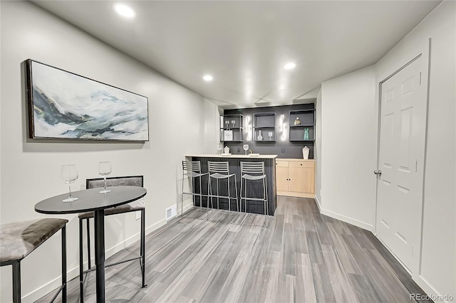 kitchen featuring light brown cabinetry and hardwood / wood-style floors