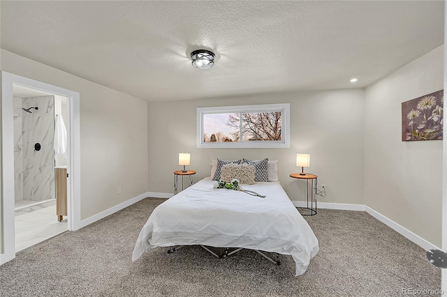 bedroom featuring connected bathroom, carpet floors, and a textured ceiling