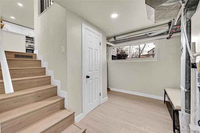 stairway with hardwood / wood-style flooring