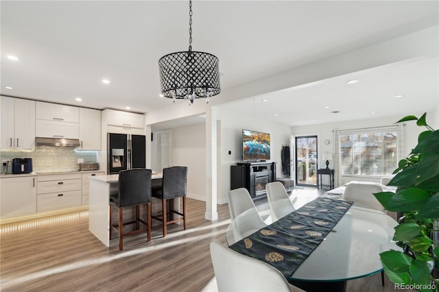 dining space featuring an inviting chandelier and light hardwood / wood-style floors