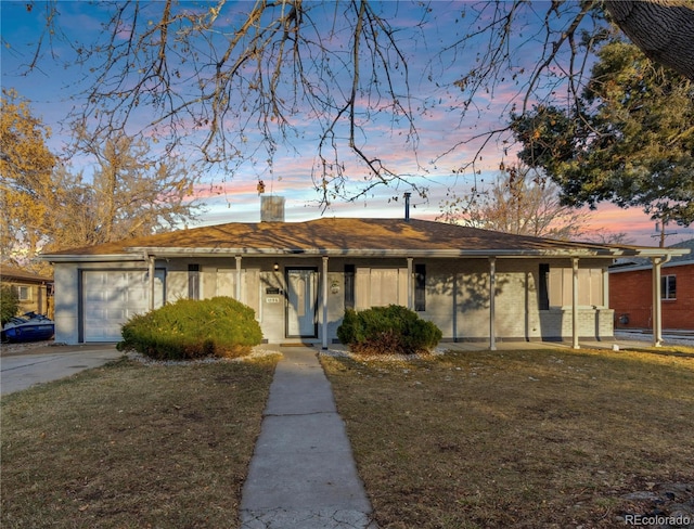 single story home with a yard and a garage