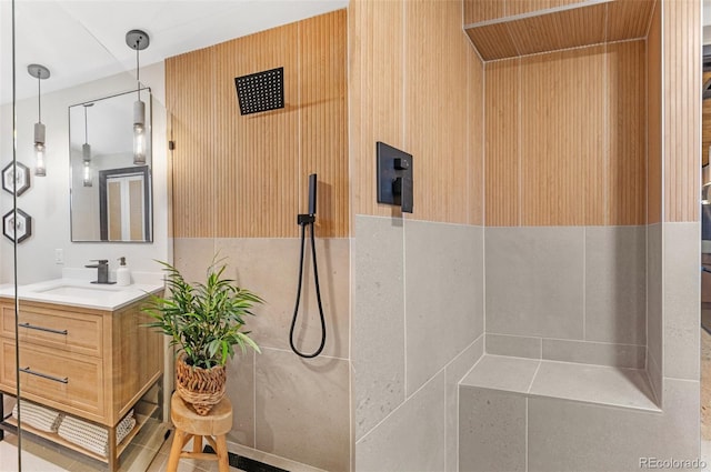 bathroom featuring walk in shower and vanity