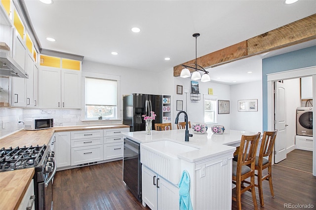 131 Faraday St, Monte Vista, CO 81144 - kitchen featuring refrigerator with ice dispenser, butcher block counters, dishwasher, dark wood-style floors, and gas range
