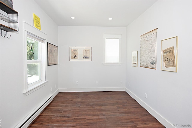 131 Faraday St, Monte Vista, CO 81144 - unfurnished room featuring a baseboard heating unit, dark wood-style floors, and recessed lighting