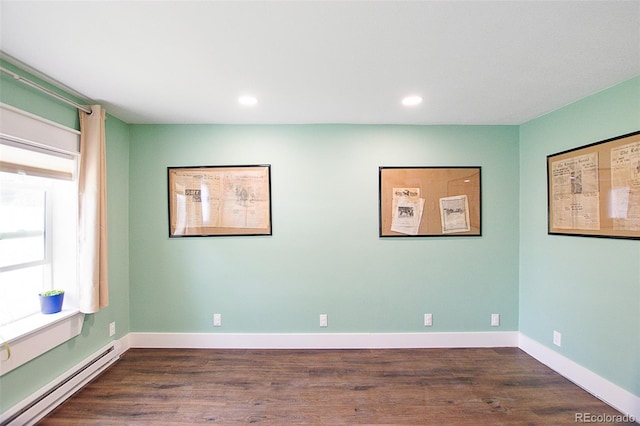 131 Faraday St, Monte Vista, CO 81144 - spare room featuring a baseboard heating unit, dark wood finished floors, and recessed lighting