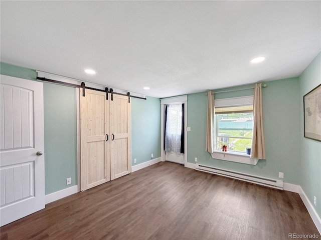 131 Faraday St, Monte Vista, CO 81144 - unfurnished bedroom with a baseboard radiator, a barn door, wood finished floors, and recessed lighting