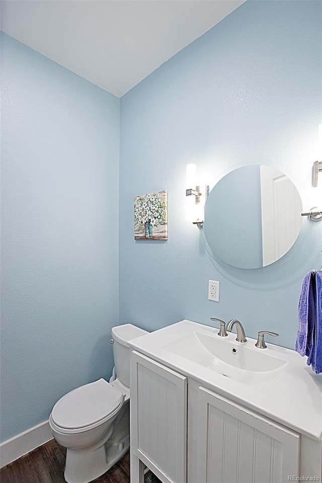 131 Faraday St, Monte Vista, CO 81144 - half bath featuring wood finished floors and vanity