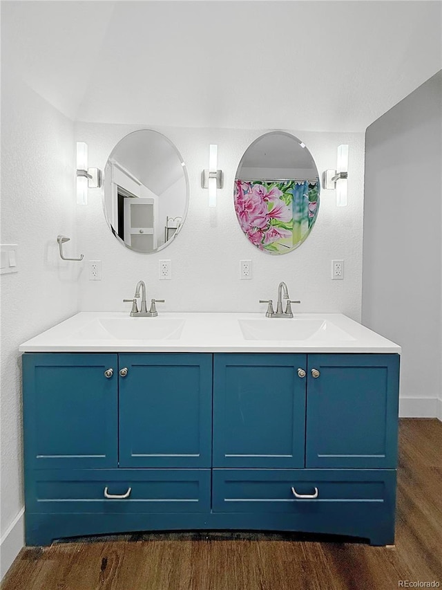 131 Faraday St, Monte Vista, CO 81144 - full bathroom featuring double vanity and wood finished floors