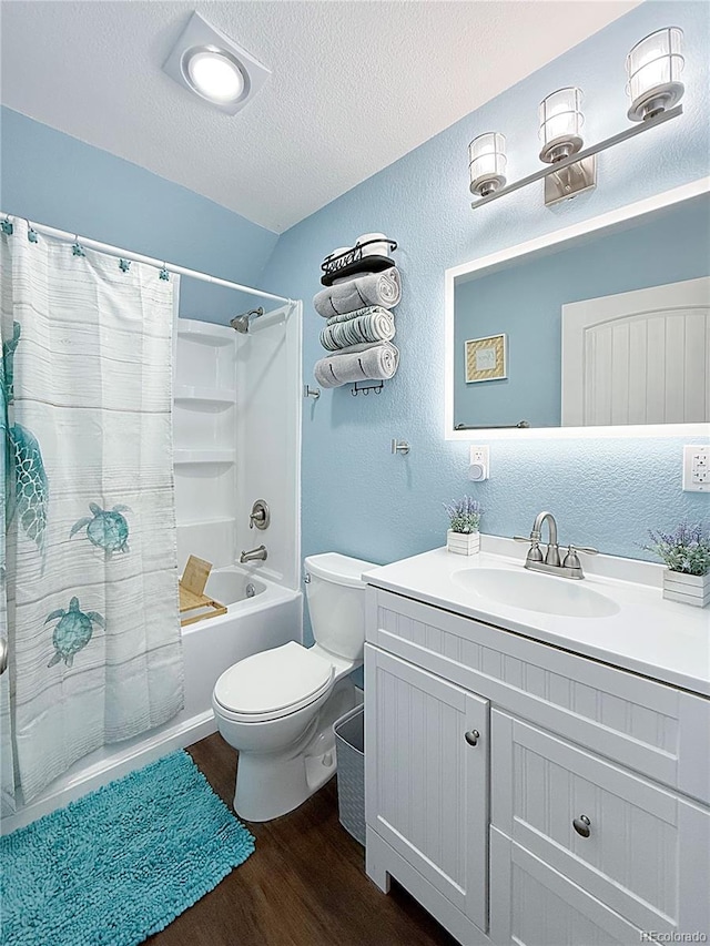 131 Faraday St, Monte Vista, CO 81144 - full bath featuring wood finished floors, vanity, shower / bathtub combination with curtain, a textured ceiling, and a textured wall