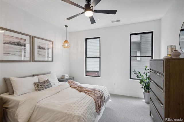 bedroom with ceiling fan and light carpet