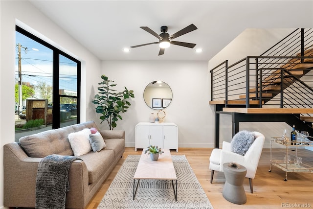 living room with ceiling fan and light hardwood / wood-style floors