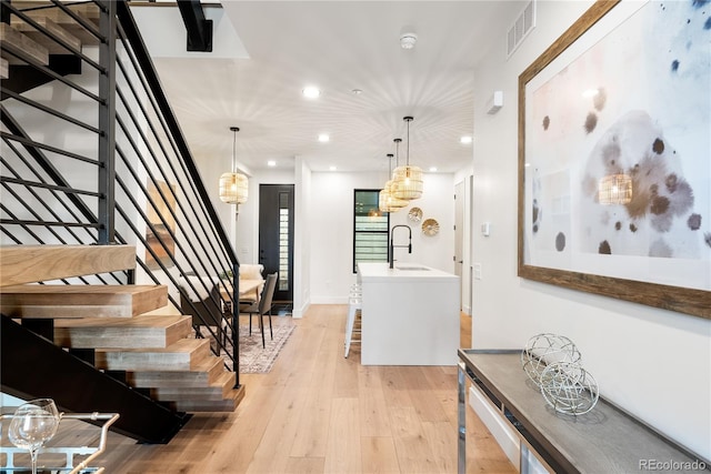 foyer featuring sink and light wood-type flooring