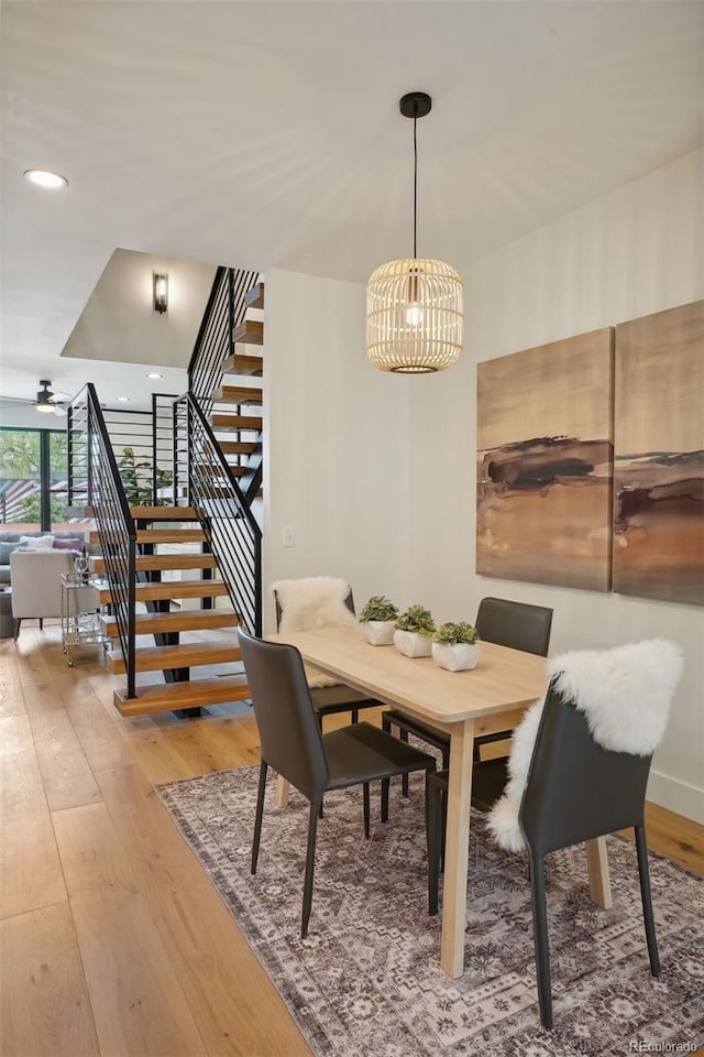 dining space featuring hardwood / wood-style floors and an inviting chandelier