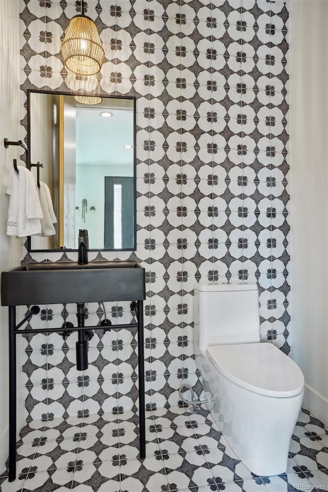 bathroom featuring sink, tile patterned floors, and toilet