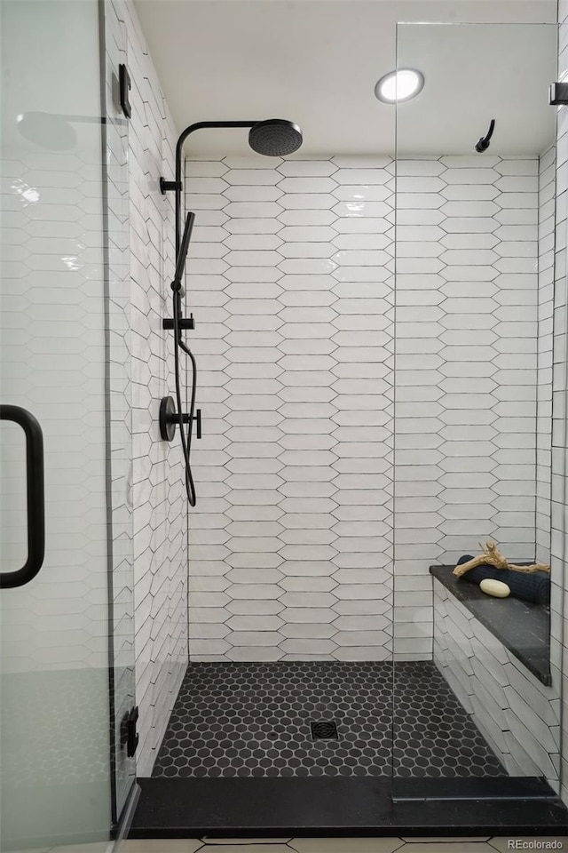 bathroom with a shower with door