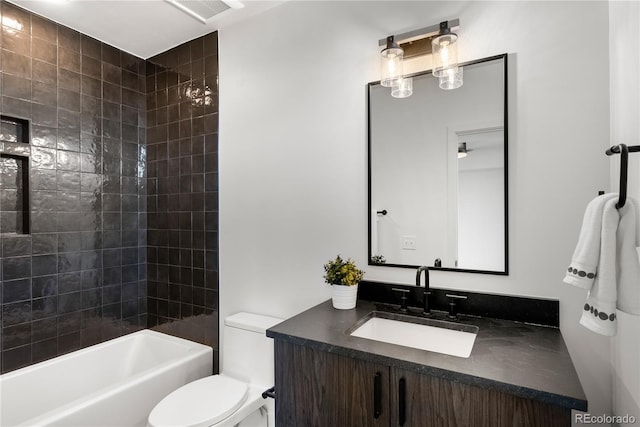 full bathroom with tiled shower / bath combo, vanity, and toilet