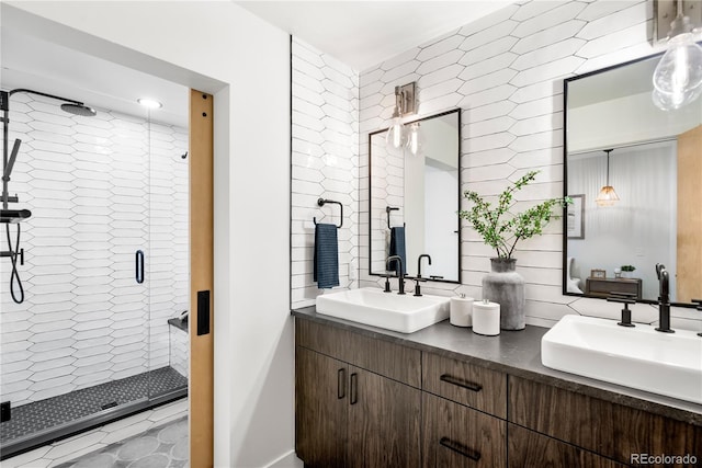 bathroom with vanity and a shower with door