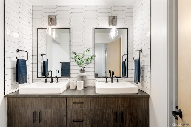 bathroom featuring tasteful backsplash, vanity, and tile walls