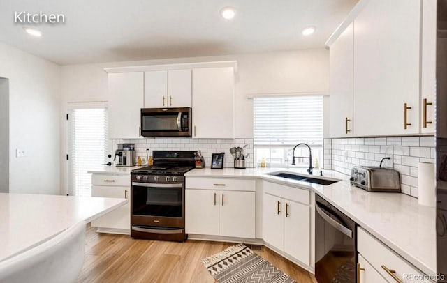 4443 N Quatar Ct, Aurora, CO 80019 - kitchen featuring stainless steel appliances, light countertops, backsplash, white cabinetry, and recessed lighting