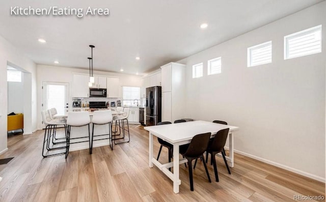 4443 N Quatar Ct, Aurora, CO 80019 - dining area with healthy amount of natural light, light wood finished floors, and recessed lighting
