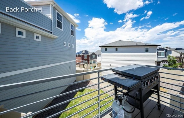 4443 N Quatar Ct, Aurora, CO 80019 - wooden terrace with a grill and a residential view