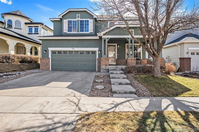 craftsman-style home featuring driveway, stucco siding, a porch, and brick siding