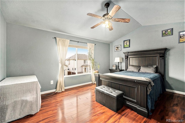 bedroom featuring ceiling fan, baseboards, vaulted ceiling, and wood finished floors