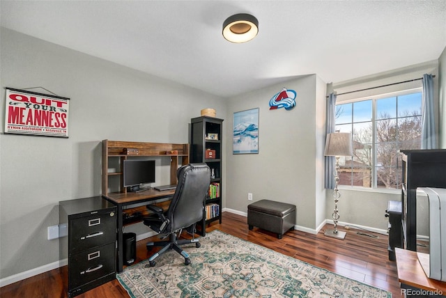 office space featuring baseboards and wood finished floors