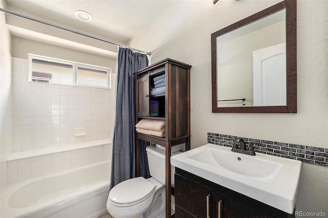 full bathroom with a textured wall, shower / bathtub combination with curtain, toilet, and vanity