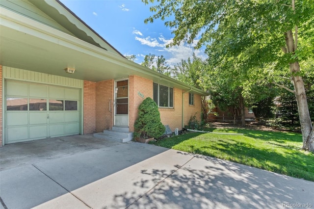 view of property exterior with brick siding, concrete driveway, a lawn, entry steps, and a garage