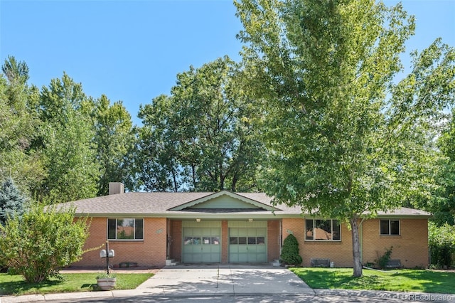 ranch-style house with an attached garage, brick siding, crawl space, and a front yard